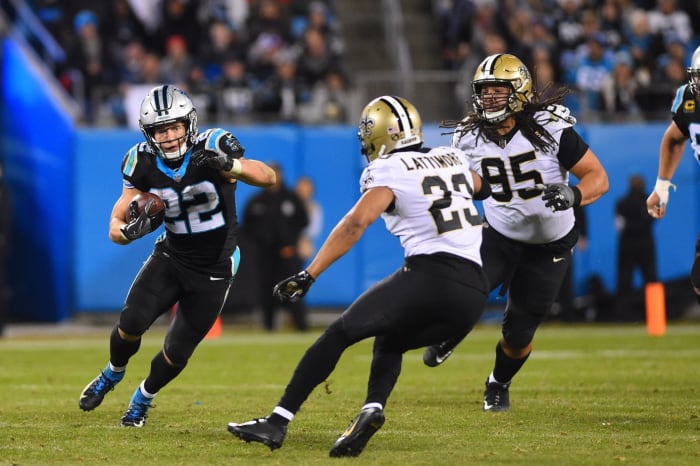 Carolina Panthers running back Christian McCaffrey (22) runs as New Orleans Saints cornerback Marshon Lattimore (23) defends. Mandatory Credit: Bob Donnan-USA TODAY Sports